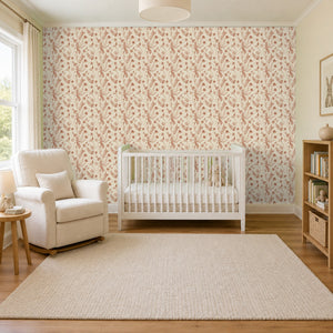Cecily Terracotta peel and stick wallpaper in a nursery with a white crib and an armchair