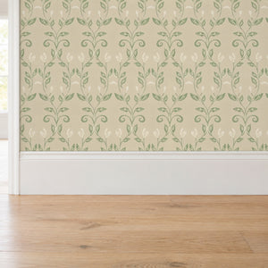 Quince Sage peel and stick wallpaper above a white baseboard and oak floor