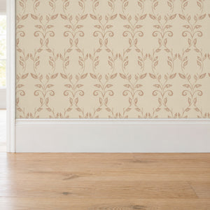 Quince Blush peel and stick wallpaper above a white baseboard and oak floor