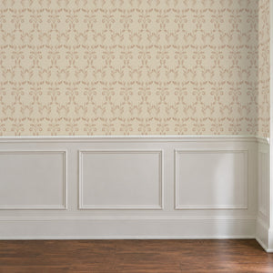 Quince Blush peel and stick wallpaper above white panel wainscoting