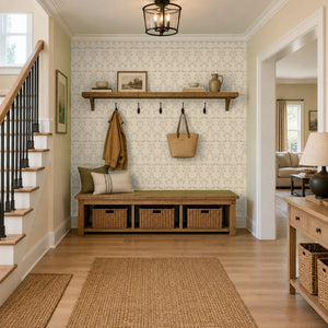 Quince Blush peel and stick wallpaper in an entry with a hook rail and a storage bench