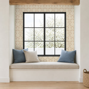 Quince Blush peel and stick wallpaper in a window seat nook with blue cushions