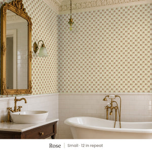 Tamsin Rose peel and stick wallpaper, small 12 in repeat, in a bathroom with a gilded mirror and a vessel sink