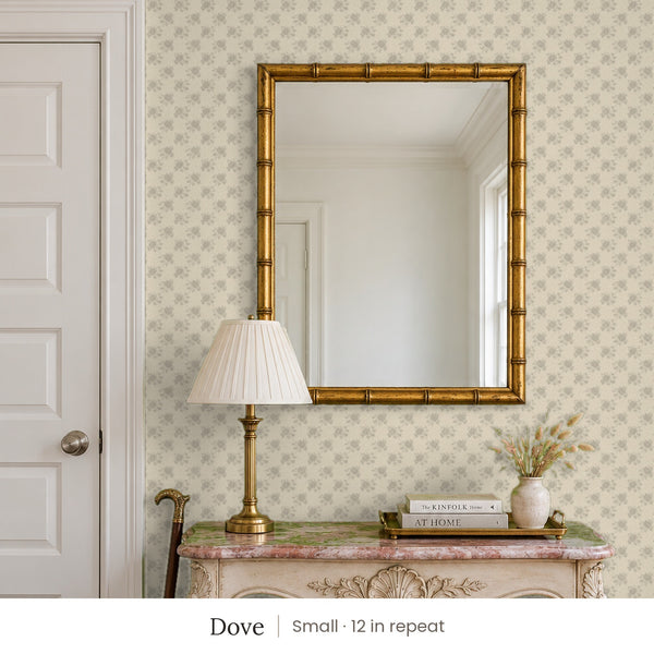 Tamsin Dove peel and stick wallpaper, small 12 in repeat, in an entry with a gold mirror and a carved console