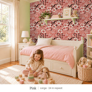 Sakura Pink peel and stick wallpaper, large 24 in repeat, in a girl's bedroom with a white daybed and a pink quilt