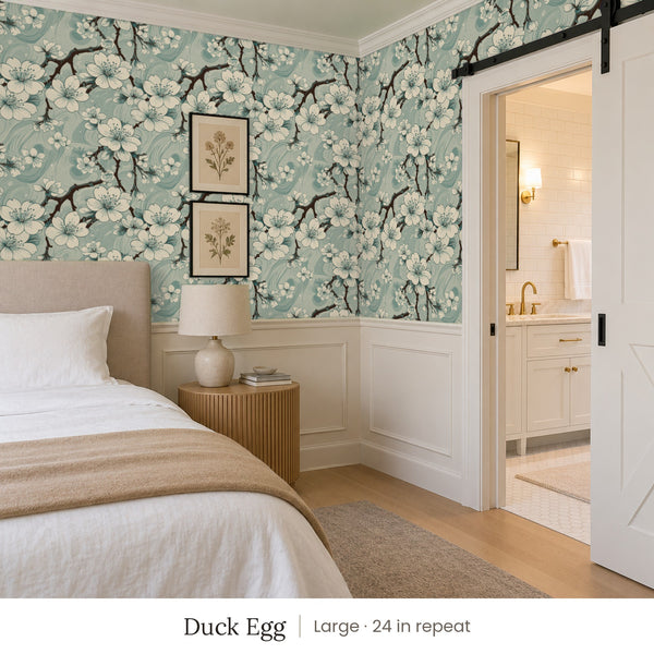 Sakura Duck Egg peel and stick wallpaper, large 24 in repeat, in a bedroom with a barn door and botanical prints