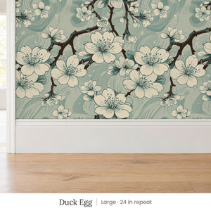 Sakura Duck Egg peel and stick wallpaper, large 24 in repeat, above a white baseboard and oak floor