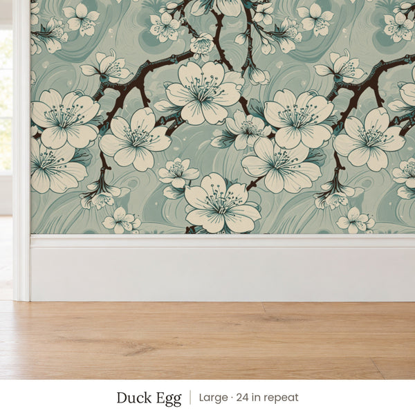 Sakura Duck Egg peel and stick wallpaper, large 24 in repeat, above a white baseboard and oak floor