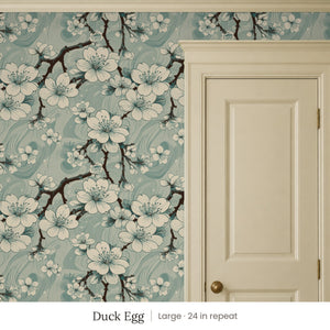 Sakura Duck Egg peel and stick wallpaper, large 24 in repeat, beside a cream panel door