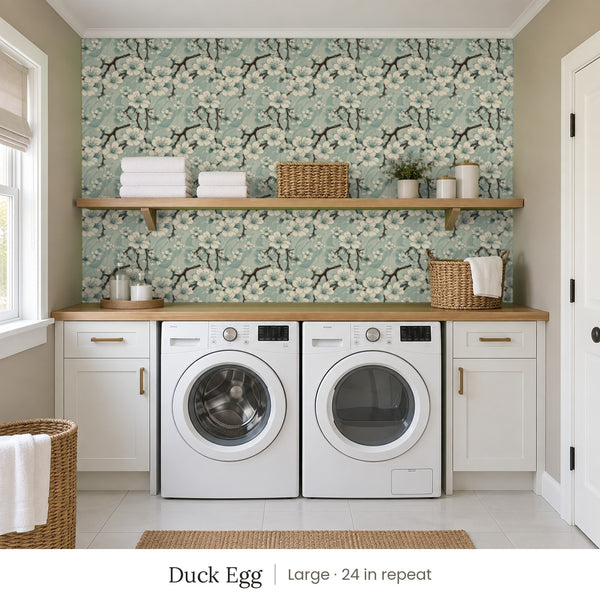 Sakura Duck Egg peel and stick wallpaper, large 24 in repeat, in a laundry room with white cabinets and open shelves