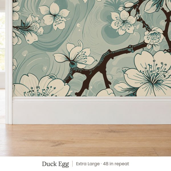 Sakura Duck Egg peel and stick wallpaper, extra large 48 in repeat, above a white baseboard and oak floor