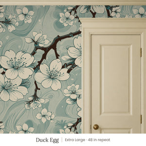 Sakura Duck Egg peel and stick wallpaper, extra large 48 in repeat, beside a cream panel door
