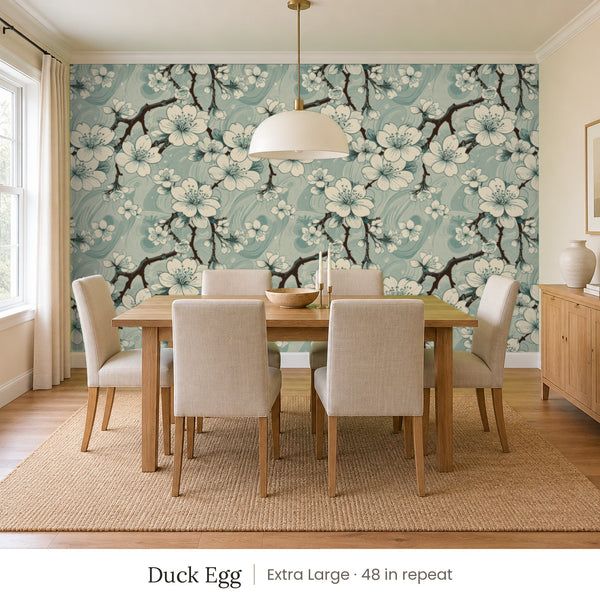 Sakura Duck Egg peel and stick wallpaper, extra large 48 in repeat, in a dining room with a wood table and upholstered chairs