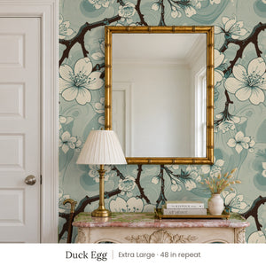 Sakura Duck Egg peel and stick wallpaper, extra large 48 in repeat, in an entry with a gold mirror and a carved console