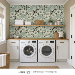 Sakura Duck Egg peel and stick wallpaper, extra large 48 in repeat, in a laundry room with white cabinets and open shelves