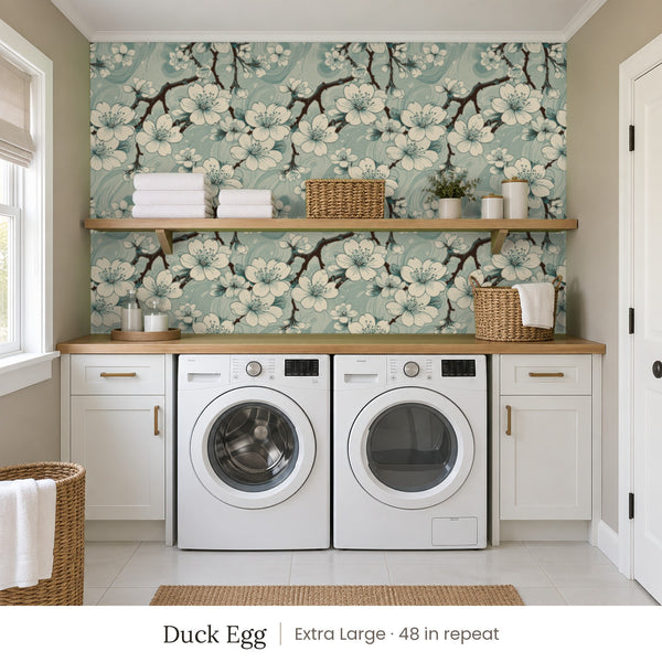 Sakura Duck Egg peel and stick wallpaper, extra large 48 in repeat, in a laundry room with white cabinets and open shelves